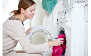 Housework: young woman doing laundry (shallow DOF; color toned i