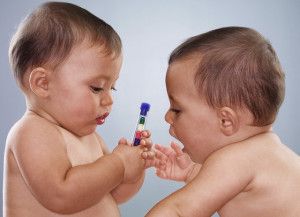 Twin Baby Girls Playing with Tube